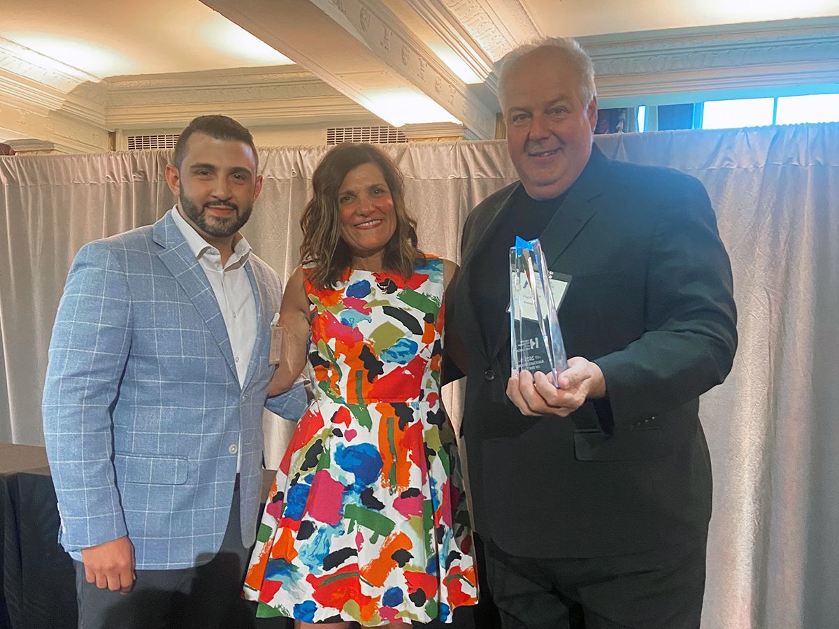 An award recipient holding a Hospitality Stars award