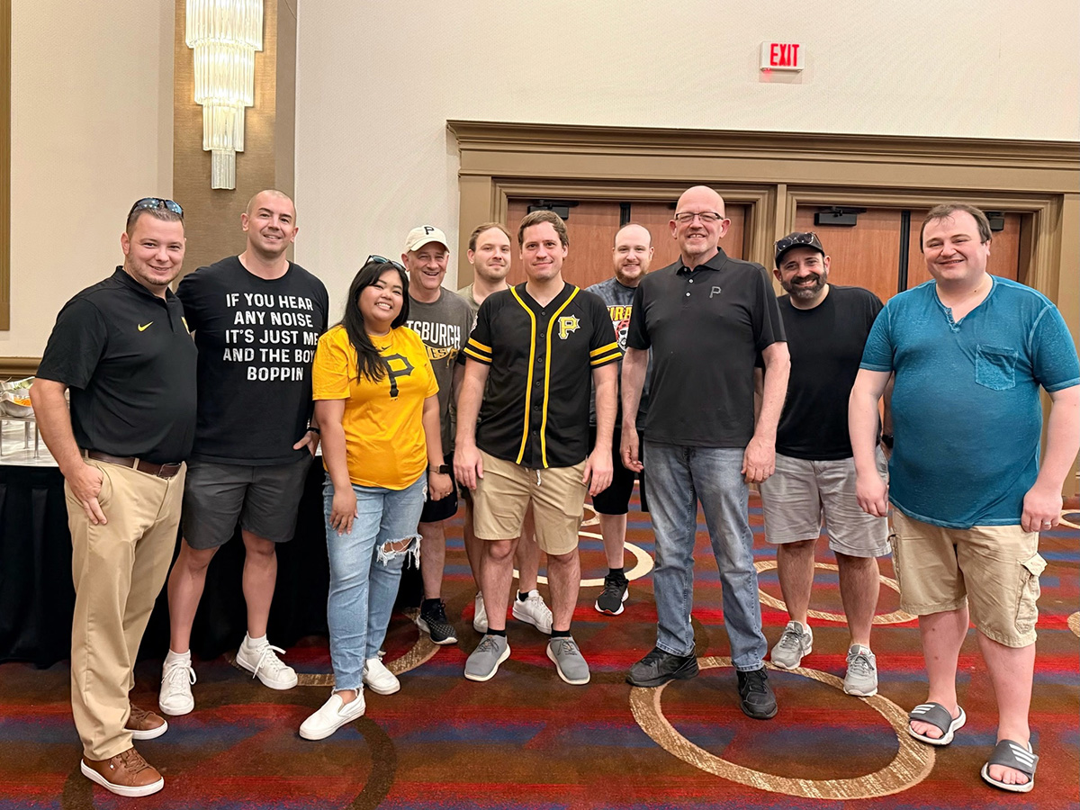 GPHA members in Pirates gear at a table during the Pirates outing