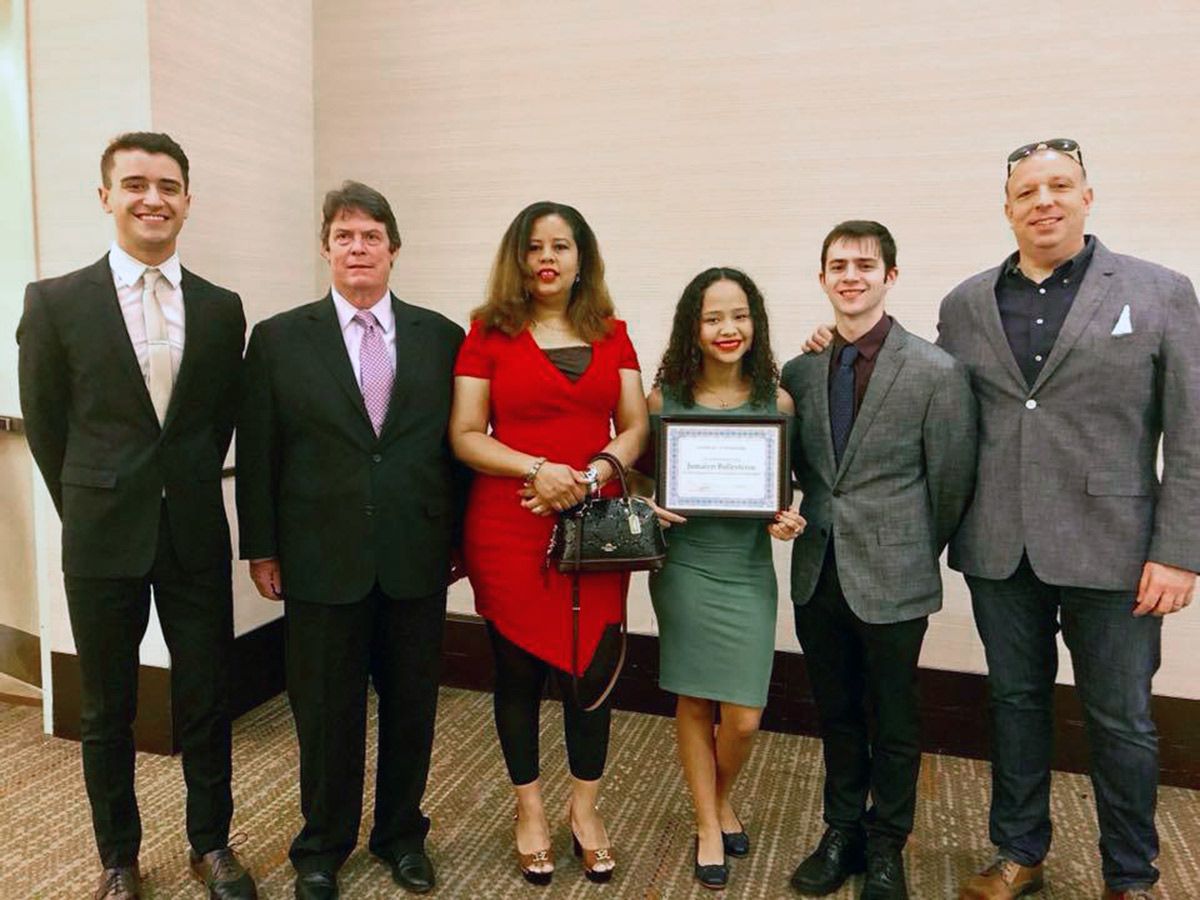 A scholarship recipient with GPHA members at a presentation